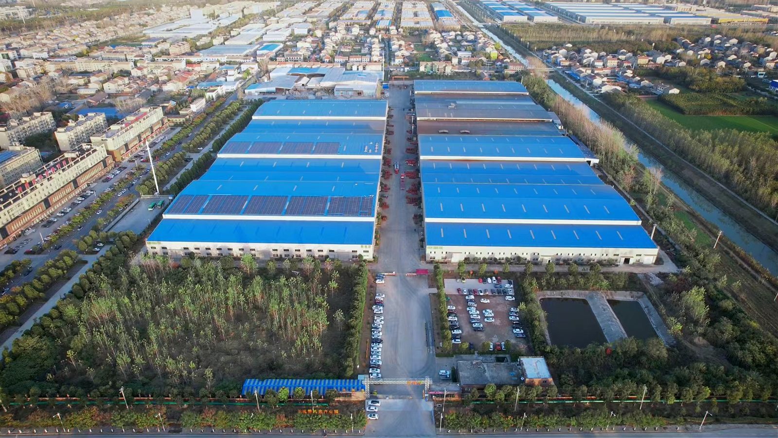 Aerial view of Tiezheng Mechanical manufacturing campus with blue-roof workshops