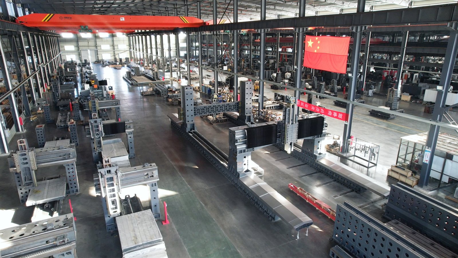 Tiezheng factory workshop image showing CNC machine production areas, assembly activity, and manufacturing environment.