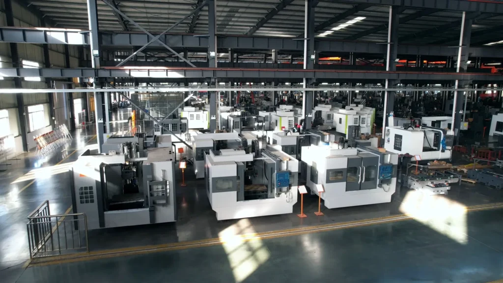 Tiezheng factory workshop image showing CNC machine production areas, assembly activity, and manufacturing environment.