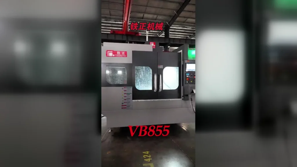 Tiezheng VB855 vertical machining center on the factory floor with the VB855 model identifier visible.